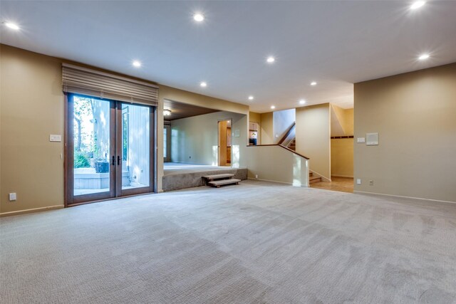 unfurnished living room featuring light colored carpet