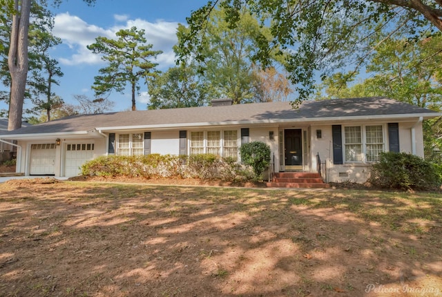 single story home with a front yard and a garage