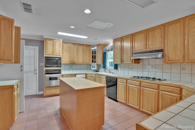 kitchen featuring light brown cabinetry, sink, black appliances, a kitchen island, and tile counters