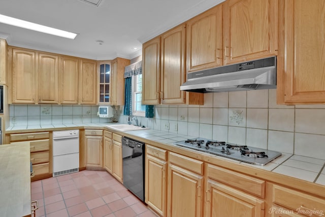 kitchen featuring tile countertops, sink, stainless steel gas stovetop, and black dishwasher