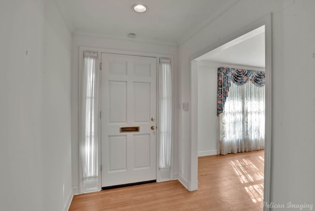 foyer entrance featuring light hardwood / wood-style flooring and ornamental molding