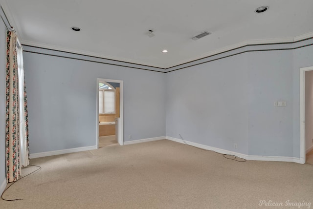 carpeted spare room featuring ornamental molding