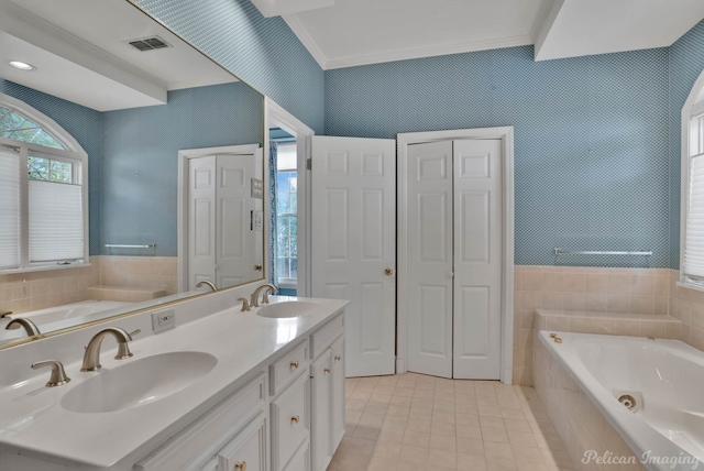 bathroom with vanity, tiled bath, tile patterned floors, and ornamental molding