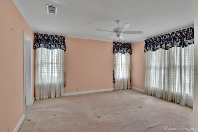 unfurnished room featuring ceiling fan, crown molding, and light colored carpet