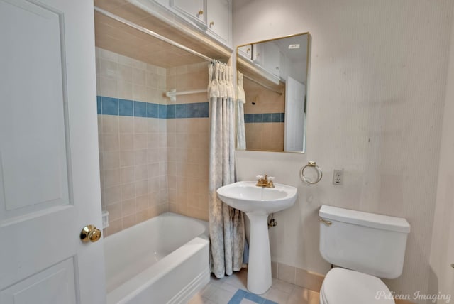 bathroom with shower / tub combo, toilet, and tile patterned flooring