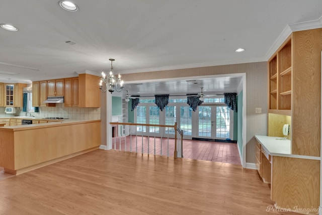 kitchen with ornamental molding, an inviting chandelier, light wood-type flooring, and french doors