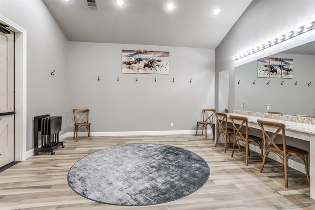 sitting room featuring light hardwood / wood-style flooring and vaulted ceiling