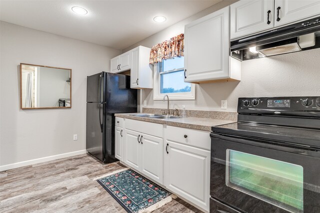 kitchen featuring light wood-type flooring, sink, white cabinetry, and black appliances