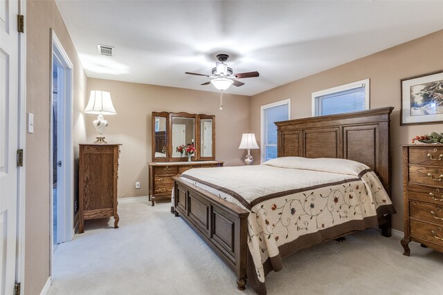 bedroom with ceiling fan and light colored carpet