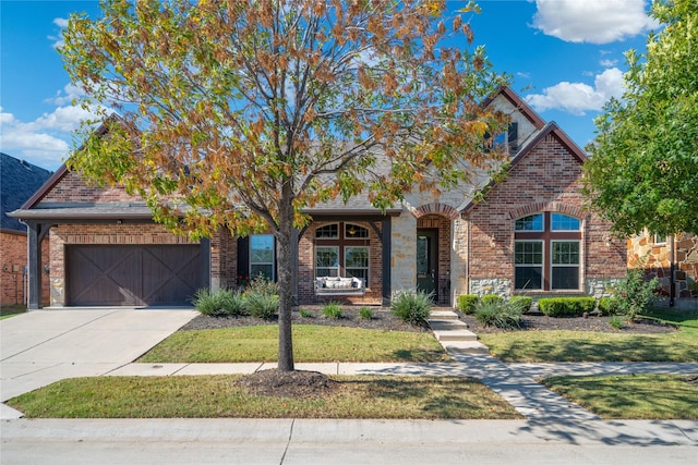 view of front of property featuring a front lawn and a garage