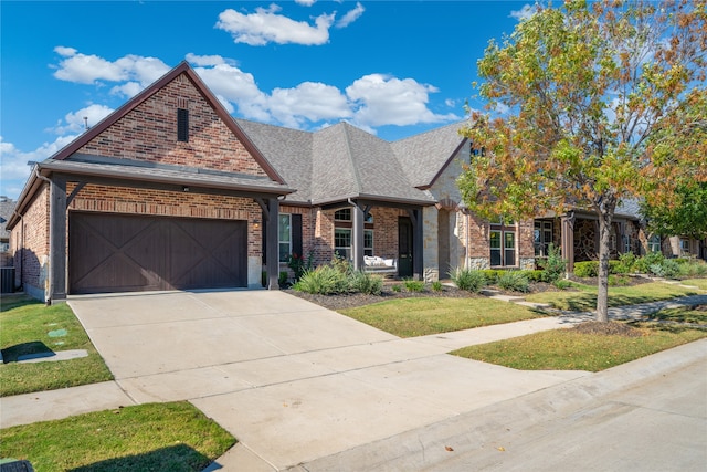 view of front of property featuring a front yard and a garage