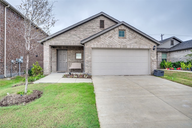 view of front of home with a garage and a front lawn