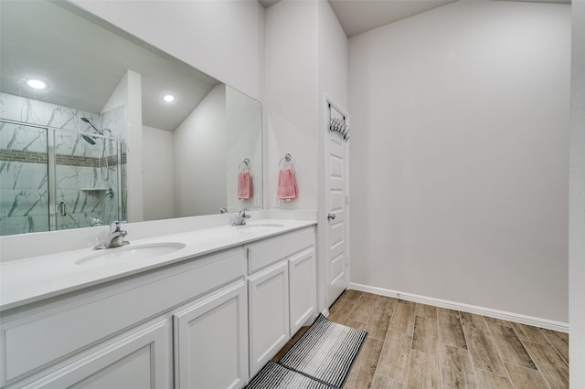 bathroom featuring vanity, hardwood / wood-style flooring, and a shower with door