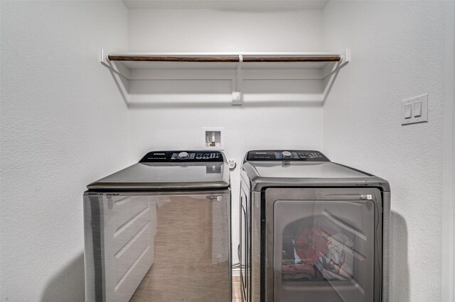 clothes washing area featuring washer and clothes dryer