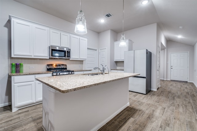 kitchen featuring stainless steel appliances, white cabinetry, and sink