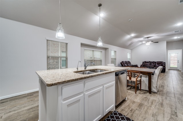 kitchen with white cabinets, sink, decorative light fixtures, dishwasher, and an island with sink