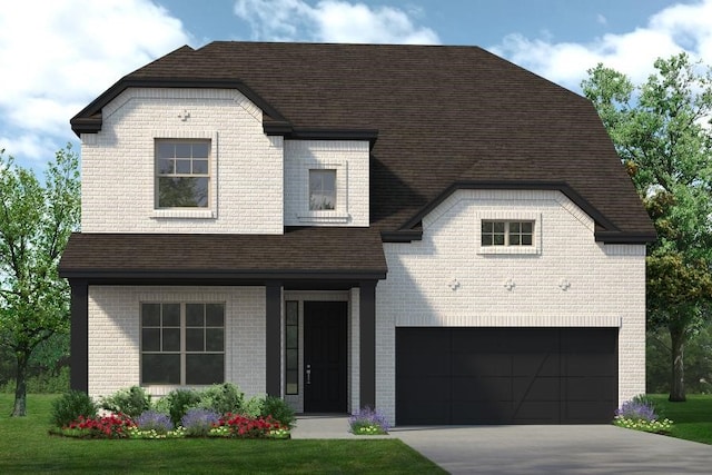 view of front of home featuring a front yard and a garage