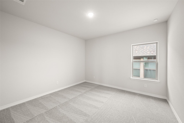 empty room with baseboards and light carpet