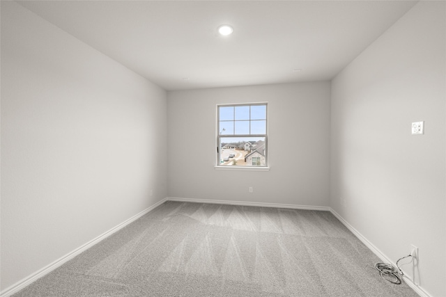 carpeted spare room with baseboards