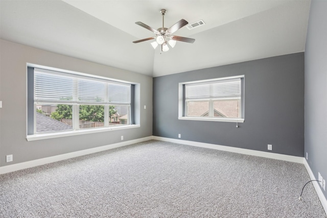 carpeted spare room featuring ceiling fan and vaulted ceiling