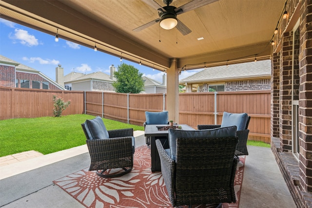 view of patio with ceiling fan and a fire pit