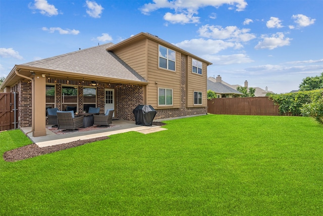 rear view of house featuring an outdoor living space, a yard, and a patio area