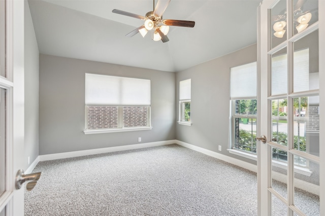 unfurnished room with vaulted ceiling, ceiling fan, and carpet floors