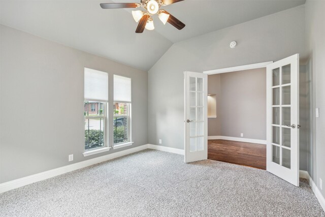 empty room featuring french doors, carpet floors, vaulted ceiling, and ceiling fan