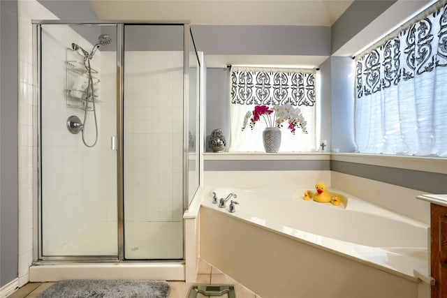 bathroom with tile patterned flooring, vanity, and separate shower and tub