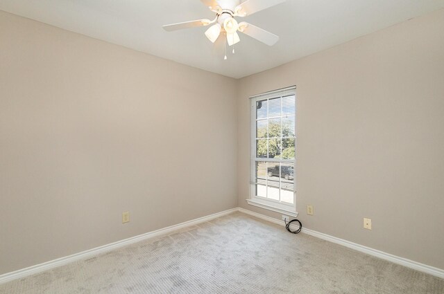 carpeted empty room featuring ceiling fan