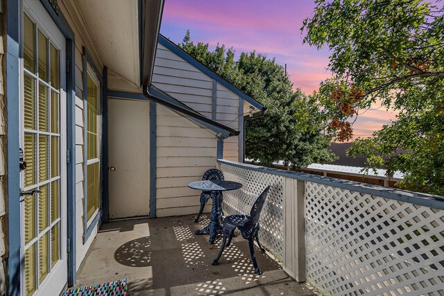 view of balcony at dusk