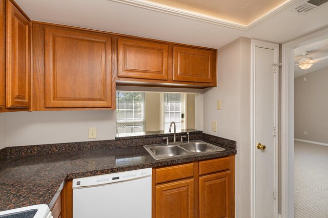 kitchen featuring white appliances, sink, ceiling fan, and carpet flooring