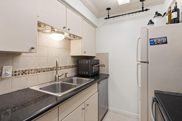 kitchen featuring tasteful backsplash, sink, ornamental molding, and appliances with stainless steel finishes