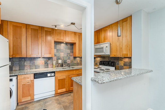 kitchen with backsplash, light stone countertops, and white appliances