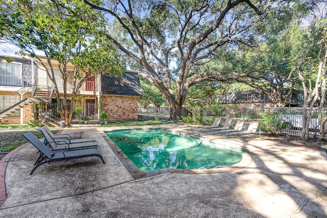 view of swimming pool with a patio area