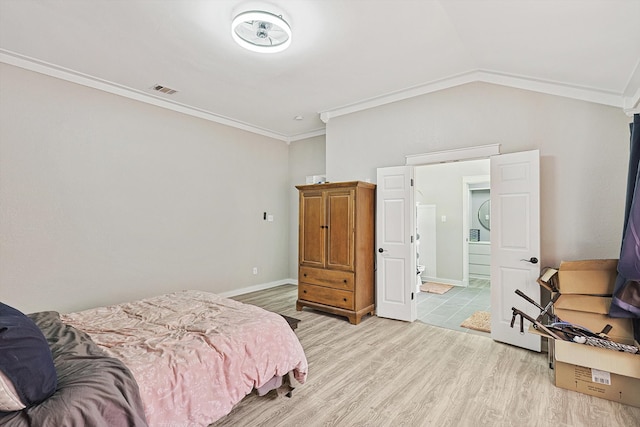 bedroom with vaulted ceiling, light hardwood / wood-style flooring, and ornamental molding