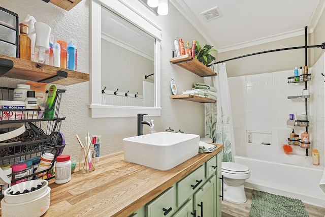 full bathroom with crown molding, wood-type flooring, toilet, shower / bath combo with shower curtain, and vanity