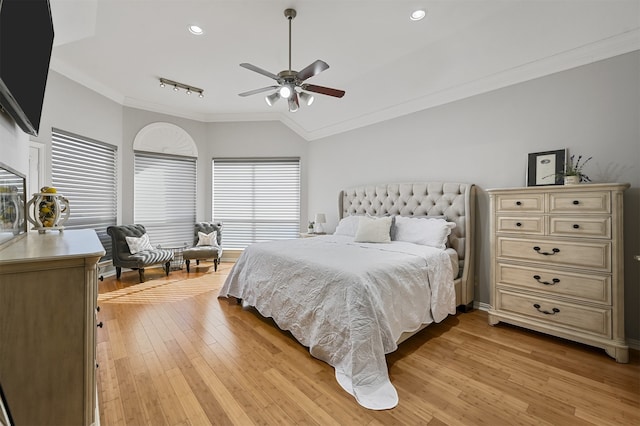 bedroom with light hardwood / wood-style flooring, ceiling fan, and crown molding