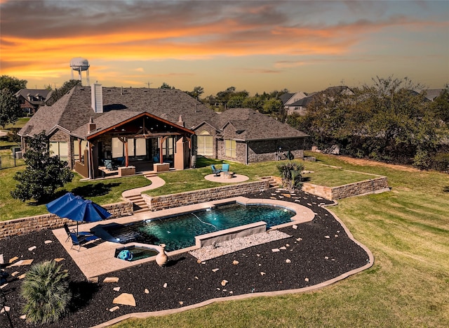 pool at dusk featuring a lawn, an outdoor hangout area, a gazebo, pool water feature, and a patio