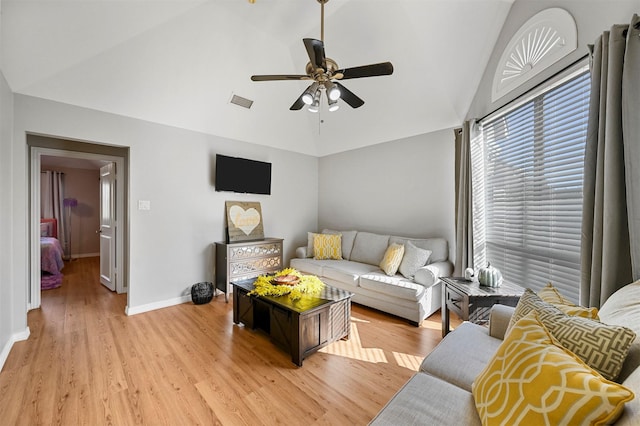 living room with ceiling fan, lofted ceiling, and light wood-type flooring