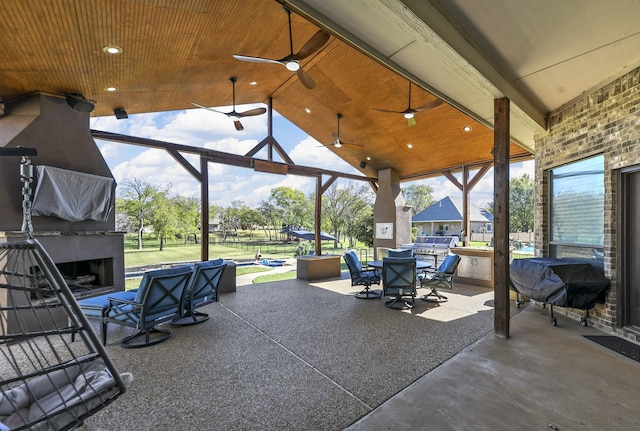 view of patio / terrace featuring a grill, ceiling fan, and exterior fireplace