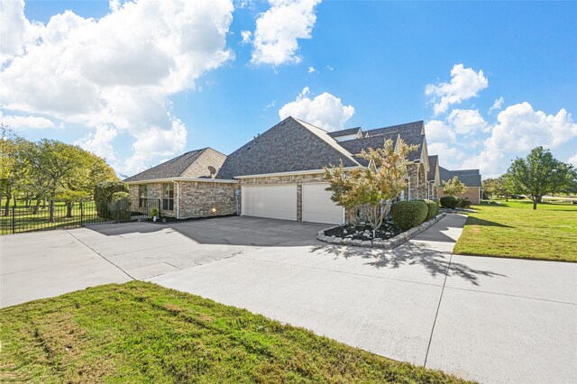 view of front of property featuring a garage and a front yard