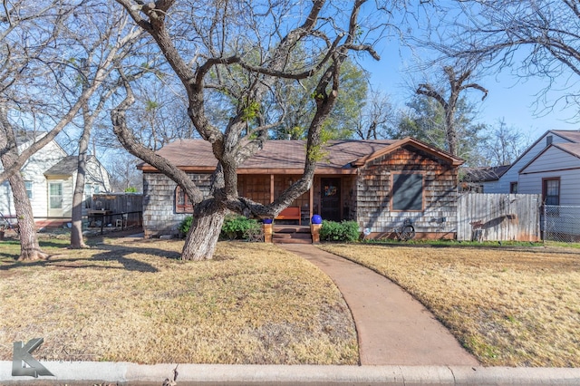 view of front of property with fence and a front lawn