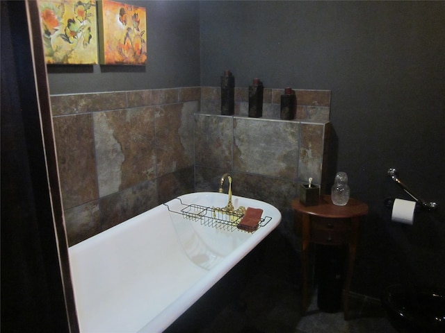 bathroom with a bath and tile walls