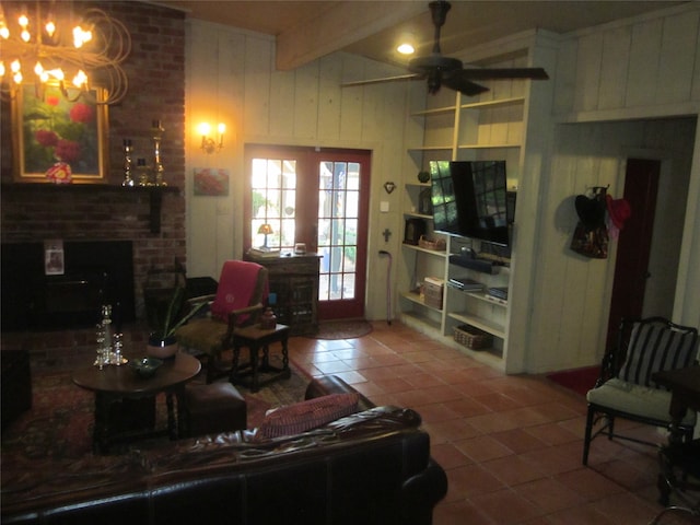 tiled living room with a fireplace, beam ceiling, ceiling fan with notable chandelier, and wood walls