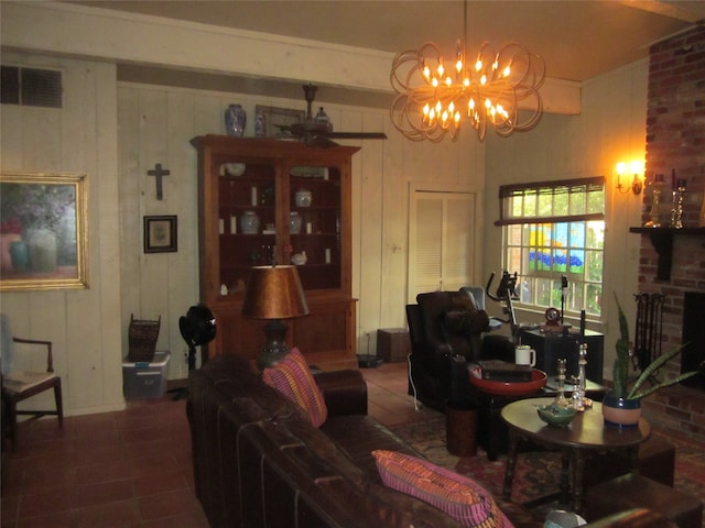 living room featuring tile patterned flooring, ceiling fan with notable chandelier, and a fireplace