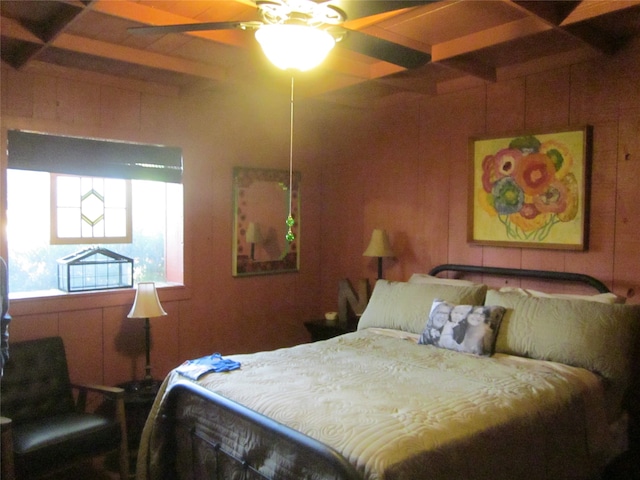 bedroom with beam ceiling, ceiling fan, and wooden walls