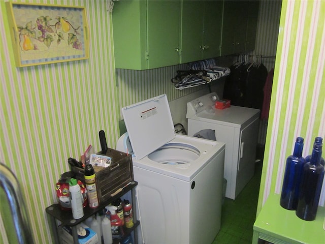 laundry area with washer and clothes dryer and cabinets