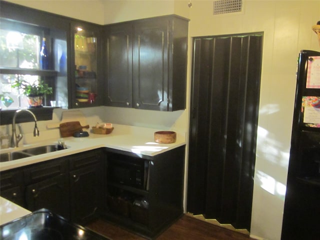 kitchen featuring dark brown cabinetry and sink