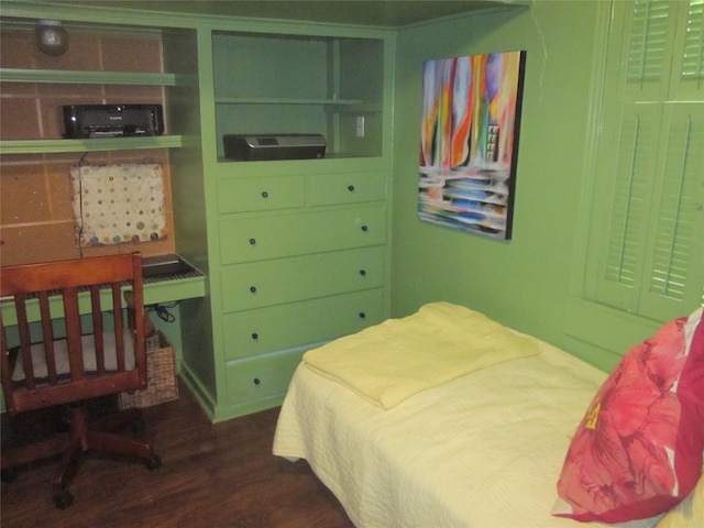 bedroom with dark hardwood / wood-style flooring